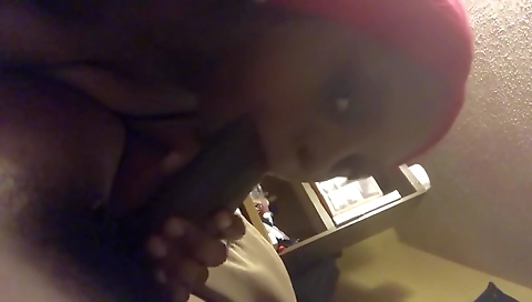 Ebony milf with big black teeth sucking a large black dick