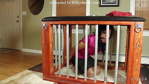 Ebony woman with a nice body is in handcuffs in a locked room