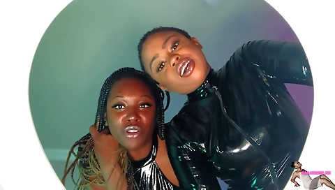 Lesbians play around with latex dress and show off their ass