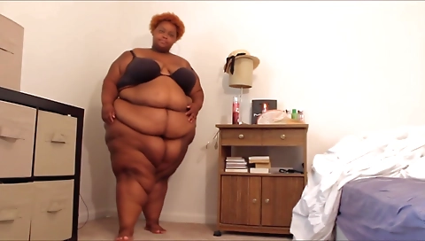 Sexy ebony babe is playing with her black cock in her room